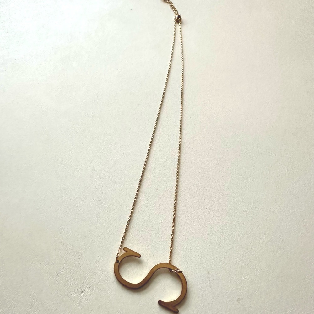 “S” gold colored necklace